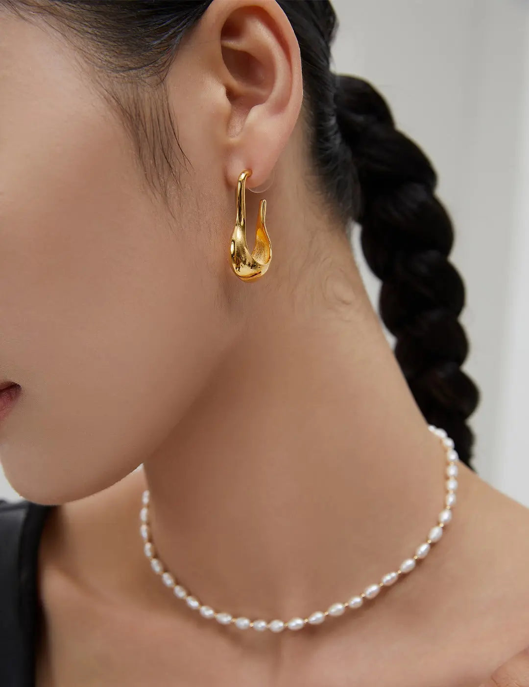 A lady wearing S925 silver earrings in 18k Gold Vermeil