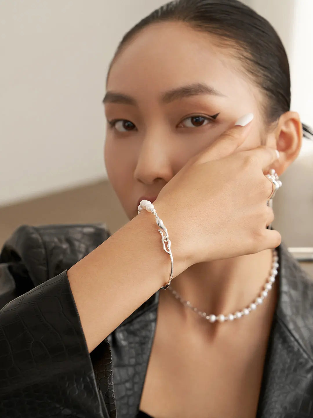 Lady wearing freshwater pearl bangle bracelet with beads and S925 silver clasp
