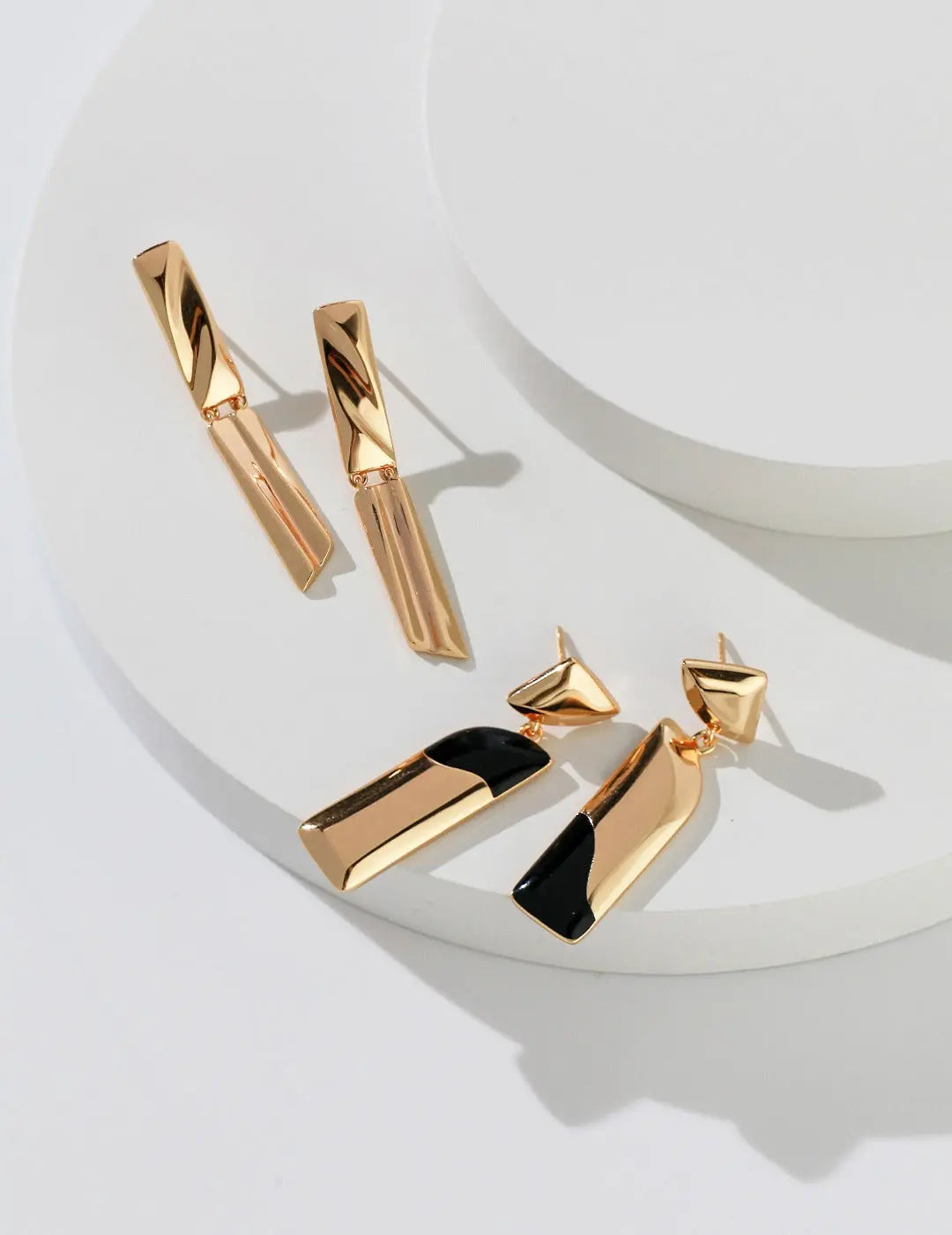 gold vermeil earrings with black drip glaze with abstract design that looks luxurious