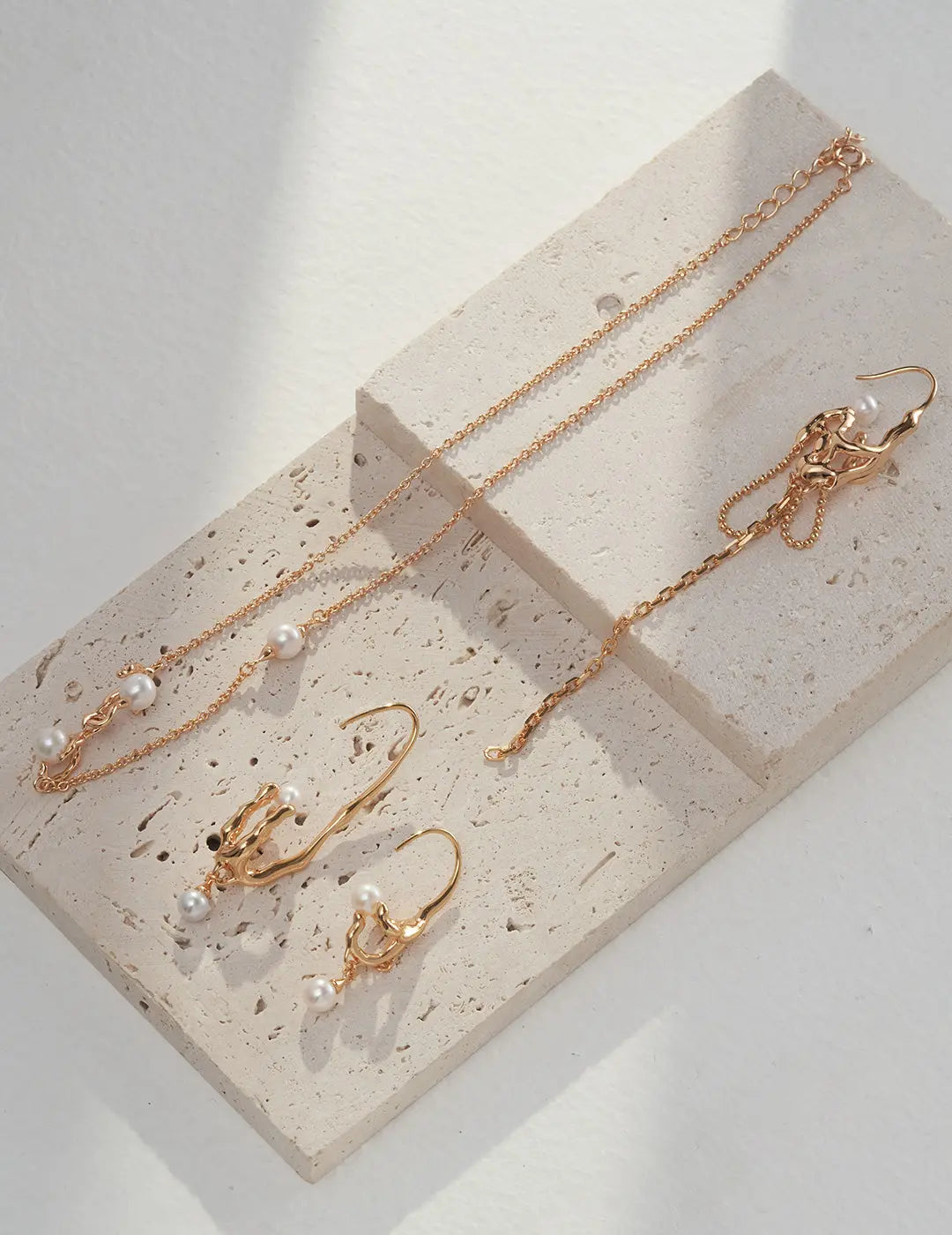 pearl drop earrings in unique hook style in 18K gold