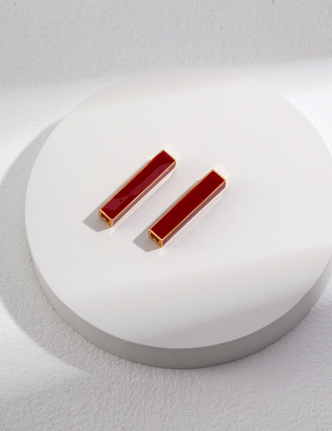 Vintage-inspired minimalist gold earrings with red glaze