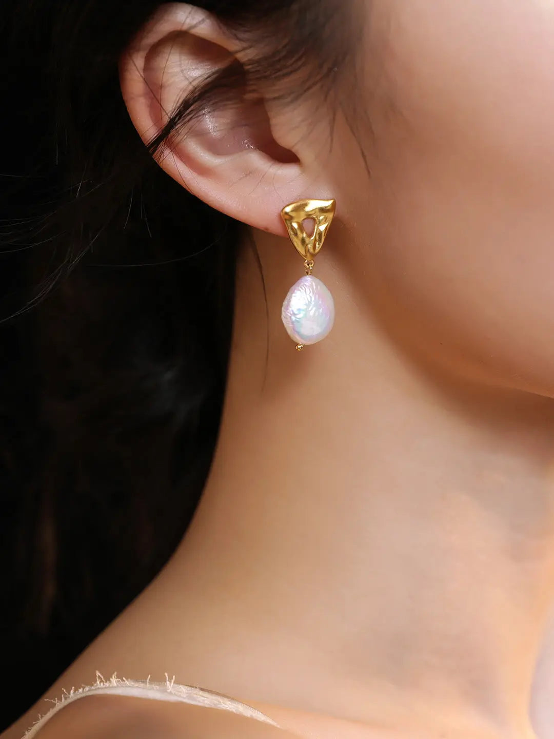 Lady wearing baroque freshwater pearl with S925 silver coated 18k gold vermeil triangle hollow out design earrings