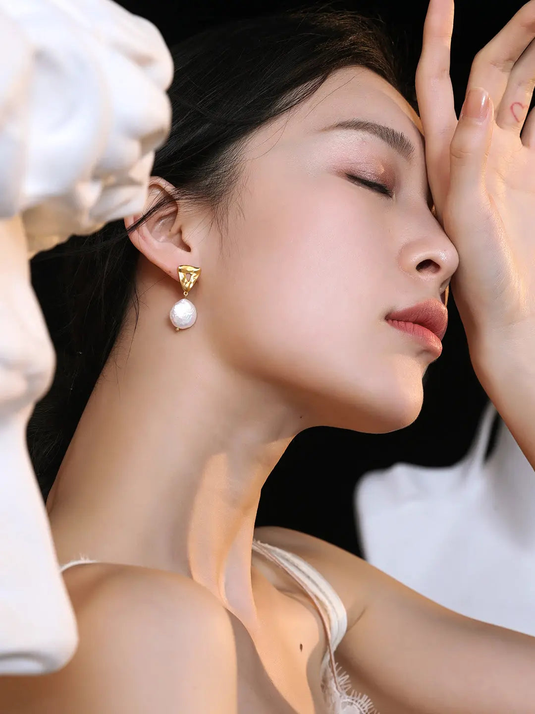 woman is wearing an Iconic Minimalistic Wedding Pearl Earrings